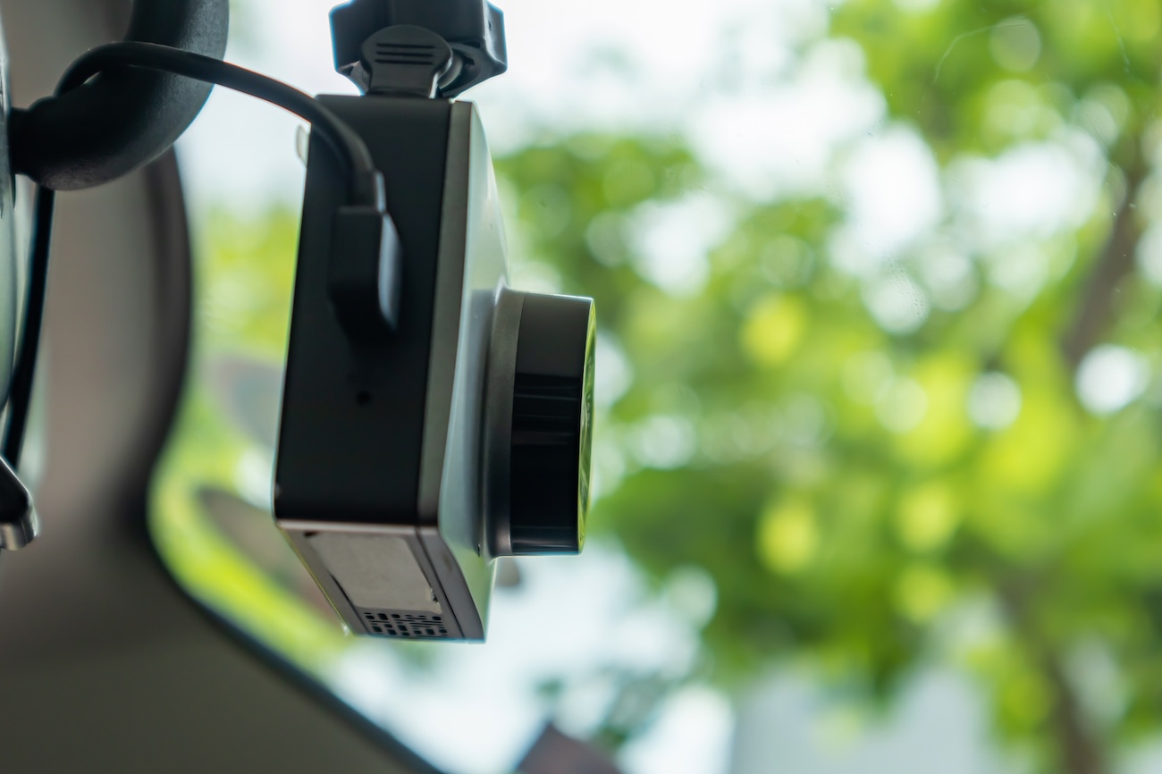 A dashcam mounted on a windshield.