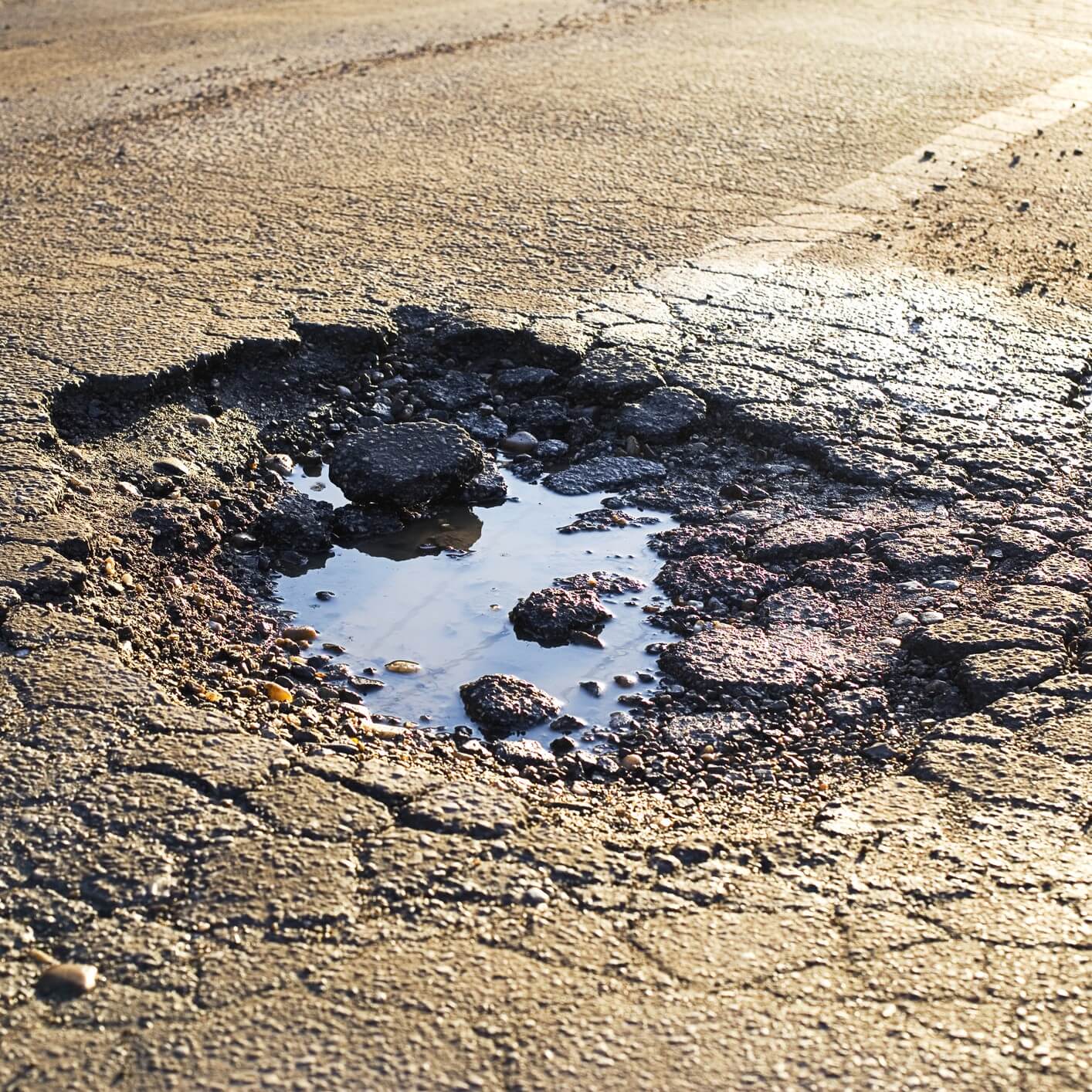 A pothole filled with water