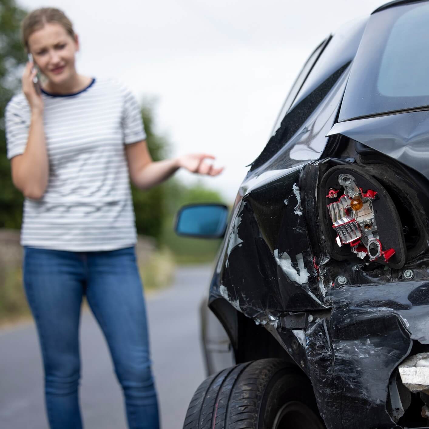 girl next to crashed car