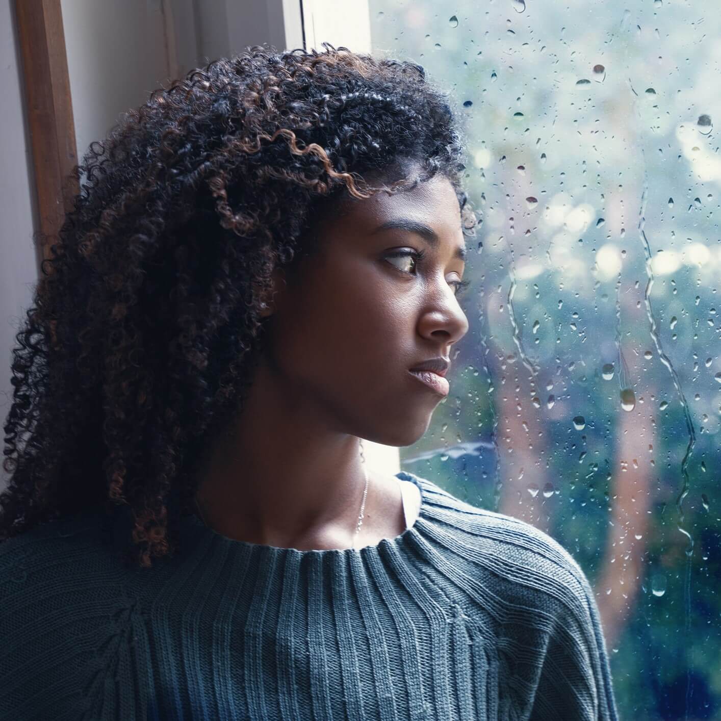 woman staring out window