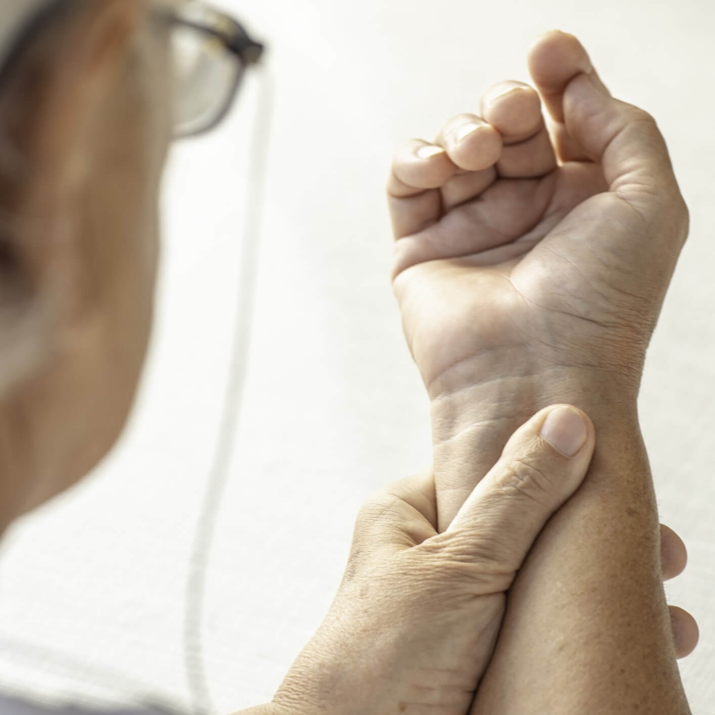 A person massaging their injured wrist