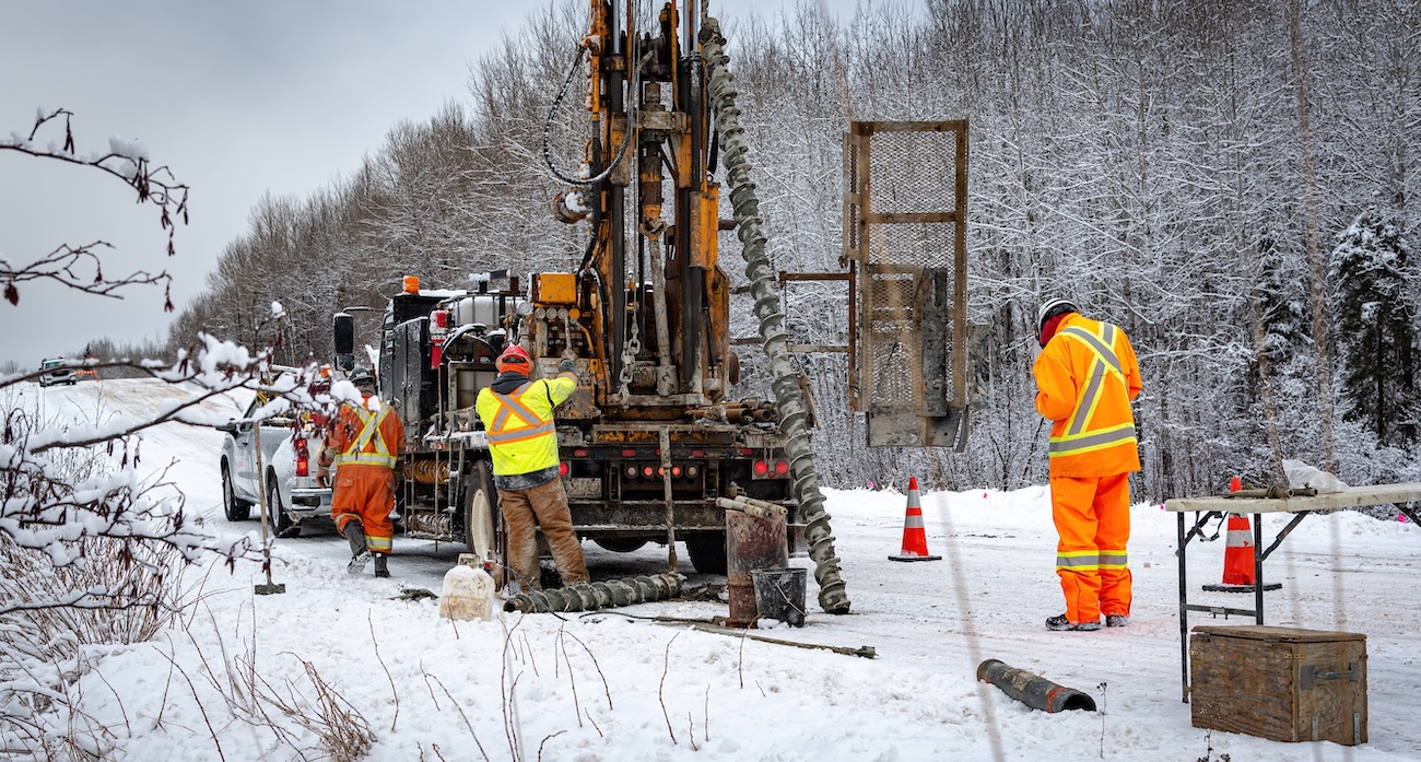 Workers on an outdoor jobsite in snow.