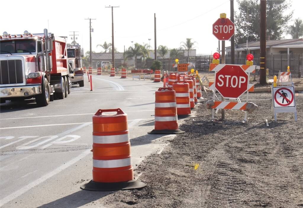 Stop signs on roadside work site.
